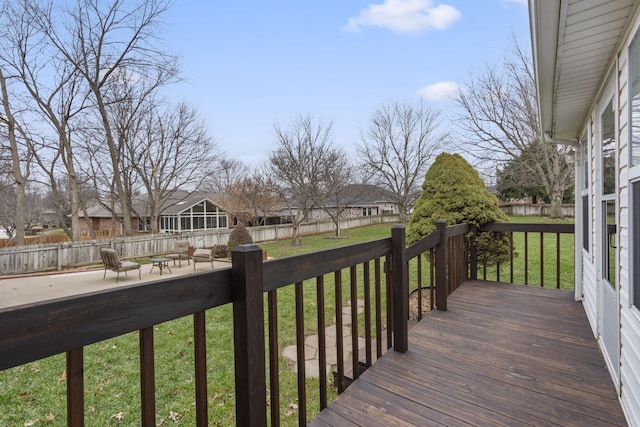 wooden terrace with a lawn