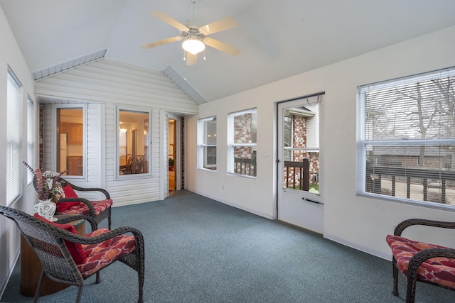 sunroom / solarium with ceiling fan, vaulted ceiling, and a wealth of natural light