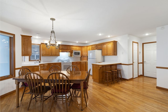 dining area featuring sink and light hardwood / wood-style flooring