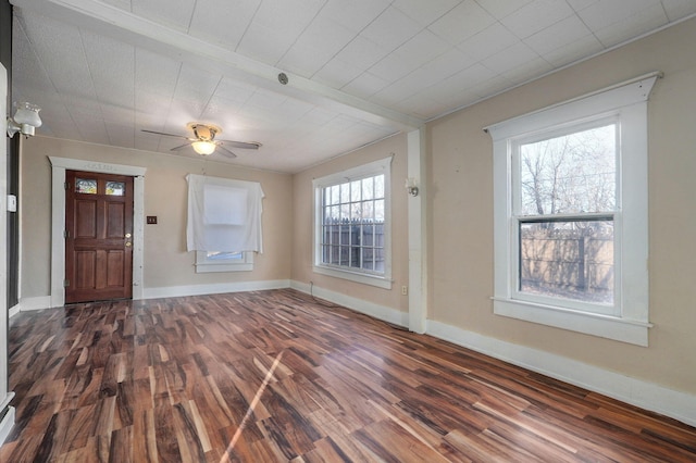 interior space featuring ceiling fan and dark wood-type flooring