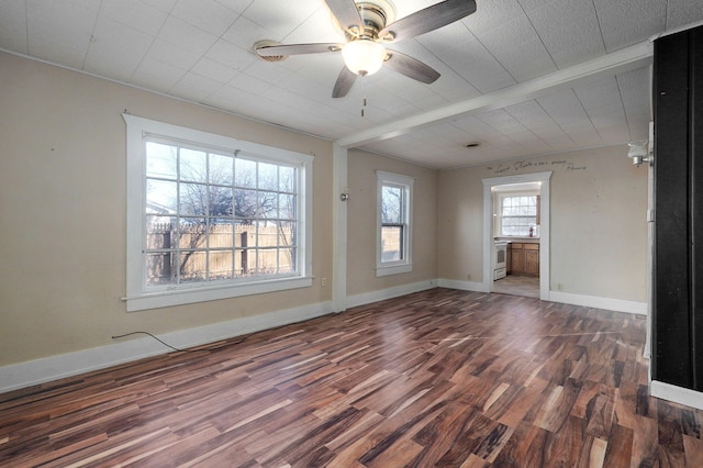 unfurnished room with ceiling fan and dark hardwood / wood-style flooring