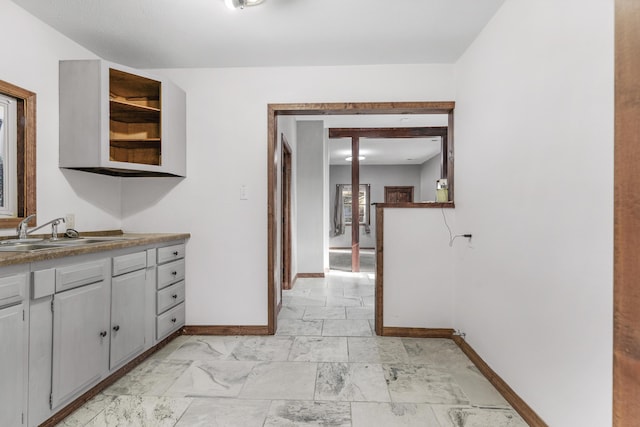 interior space with sink and gray cabinets