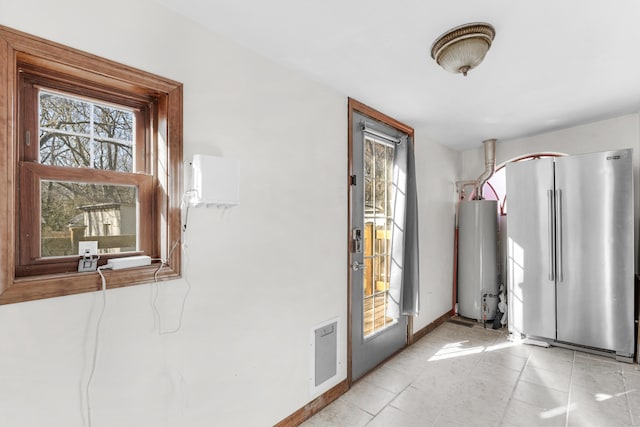 tiled entrance foyer featuring water heater