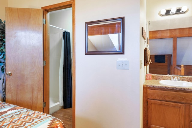 bathroom featuring vanity, a shower with curtain, and wood-type flooring