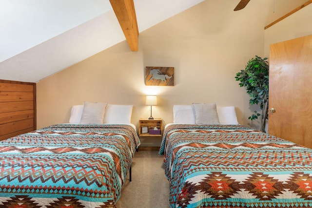 carpeted bedroom featuring lofted ceiling with beams and ceiling fan