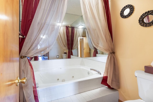 bathroom featuring toilet and tiled bath