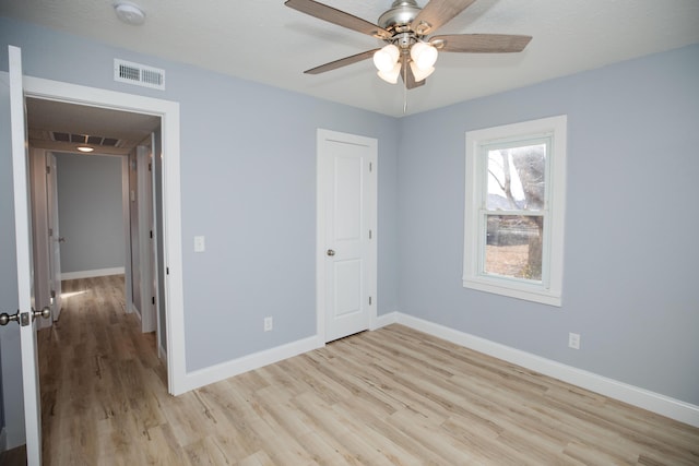 unfurnished bedroom featuring ceiling fan and light hardwood / wood-style flooring