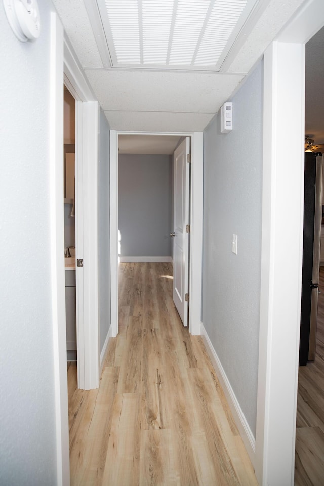 corridor with light wood-type flooring