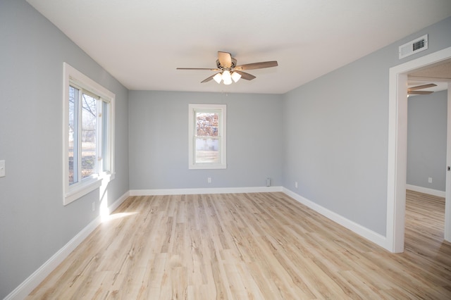 spare room featuring light wood-type flooring and ceiling fan