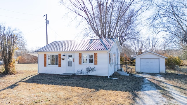 view of front of home with a garage and an outdoor structure