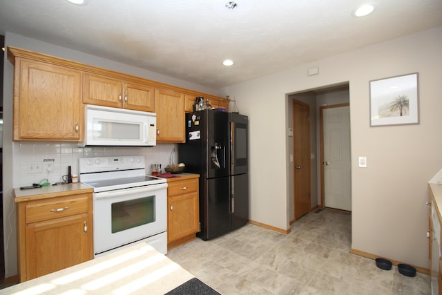 kitchen featuring backsplash and white appliances