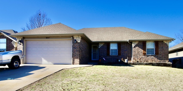 single story home with a garage and a front lawn