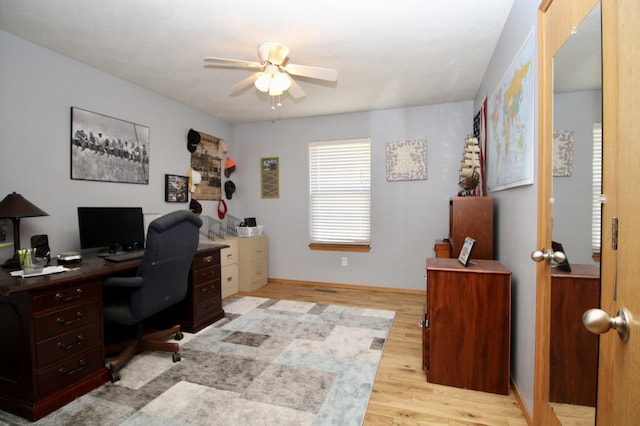 home office featuring ceiling fan and light hardwood / wood-style floors