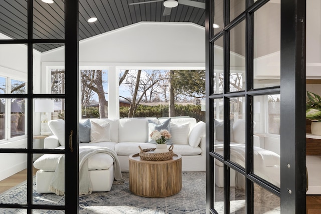 sunroom featuring vaulted ceiling and a healthy amount of sunlight