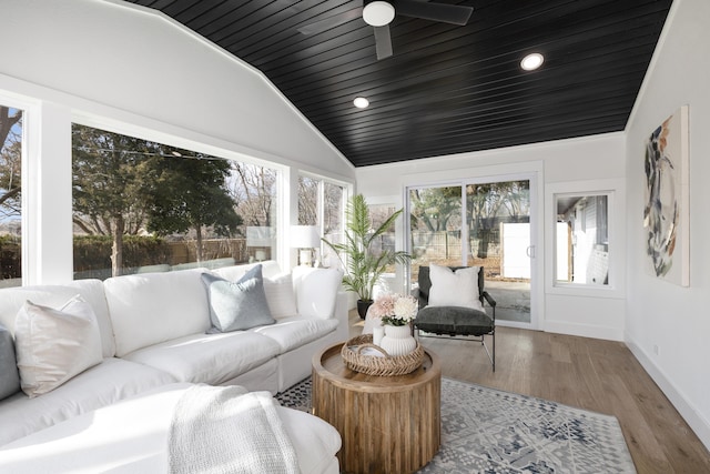 sunroom with vaulted ceiling, ceiling fan, and wooden ceiling