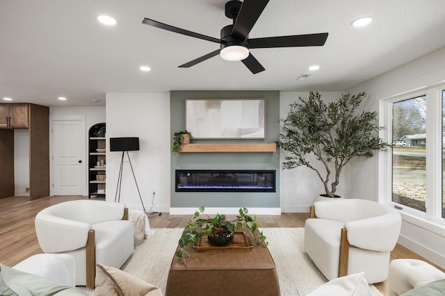 living room featuring light wood-type flooring and ceiling fan