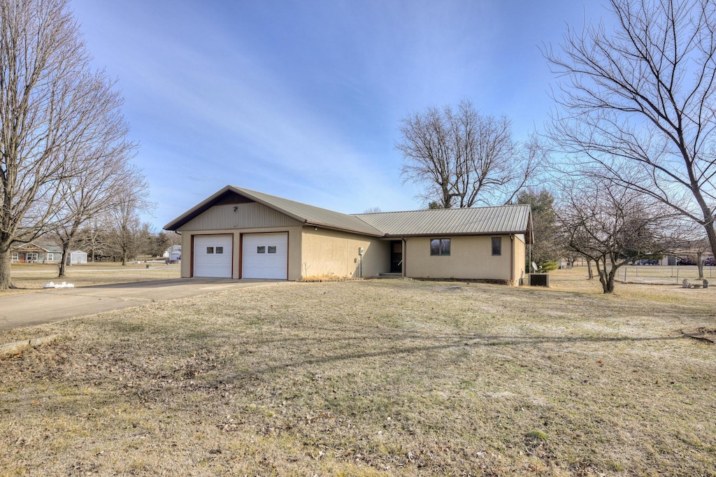 ranch-style home with a garage and a front yard