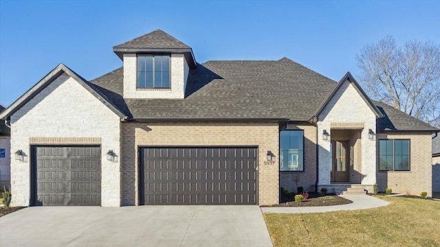 view of front of property with a garage and a front yard