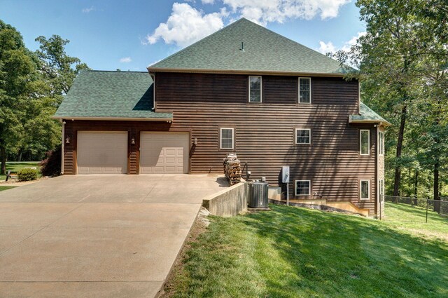 10350 Indian Ridge Ln, Carthage, MO 64836 - view of property exterior featuring an attached garage, concrete driveway, roof with shingles, and cooling unit