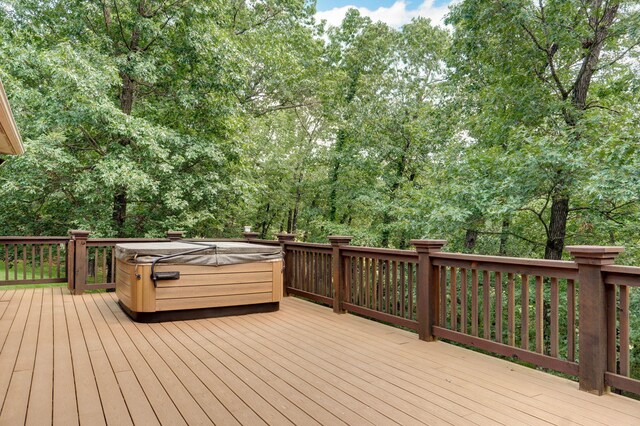 10350 Indian Ridge Ln, Carthage, MO 64836 - wooden deck with a hot tub and view of wooded area