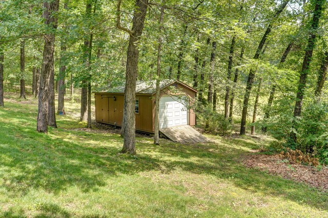 10350 Indian Ridge Ln, Carthage, MO 64836 - view of grassy yard with an outdoor structure, a wooded view, and a detached garage