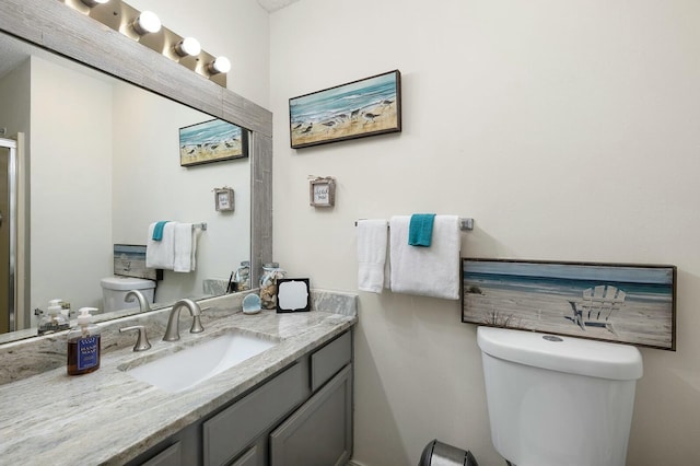 bathroom with toilet and vanity