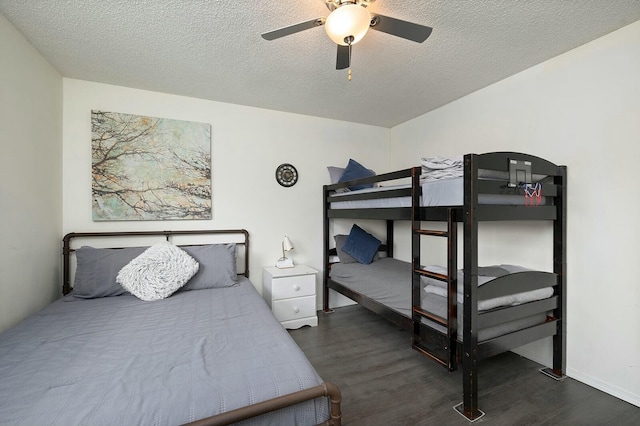 bedroom with ceiling fan, dark hardwood / wood-style flooring, and a textured ceiling