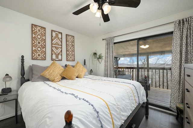 bedroom with a textured ceiling, access to exterior, ceiling fan, and dark hardwood / wood-style flooring