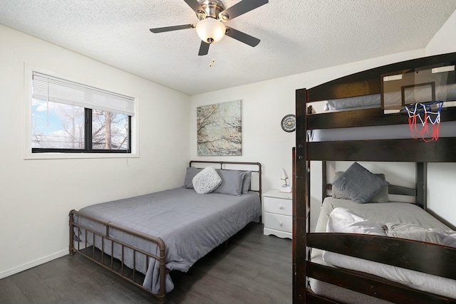 bedroom with ceiling fan, dark wood-type flooring, and a textured ceiling