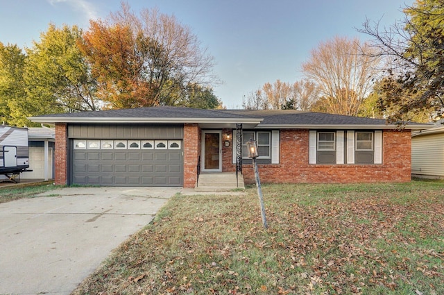 ranch-style home with a garage and a front yard