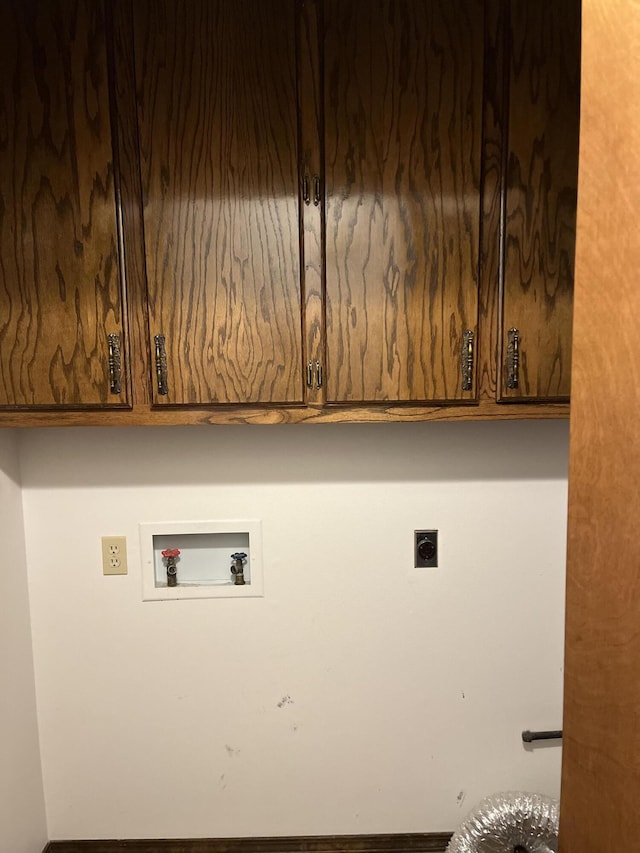 washroom featuring hookup for a washing machine, cabinets, and hookup for an electric dryer