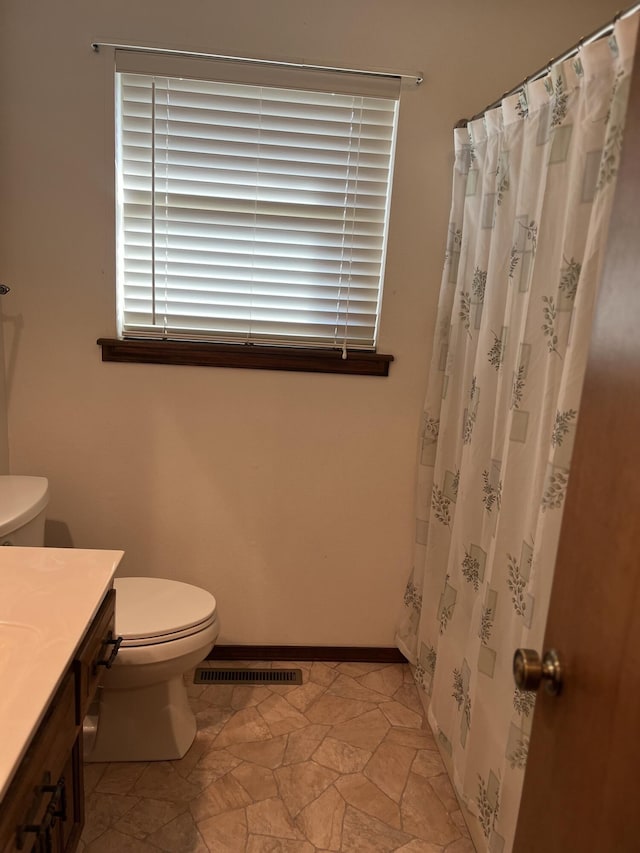 bathroom with toilet and vanity