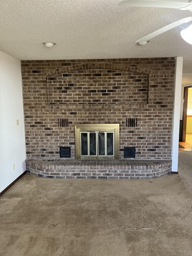 unfurnished living room featuring carpet flooring and a textured ceiling