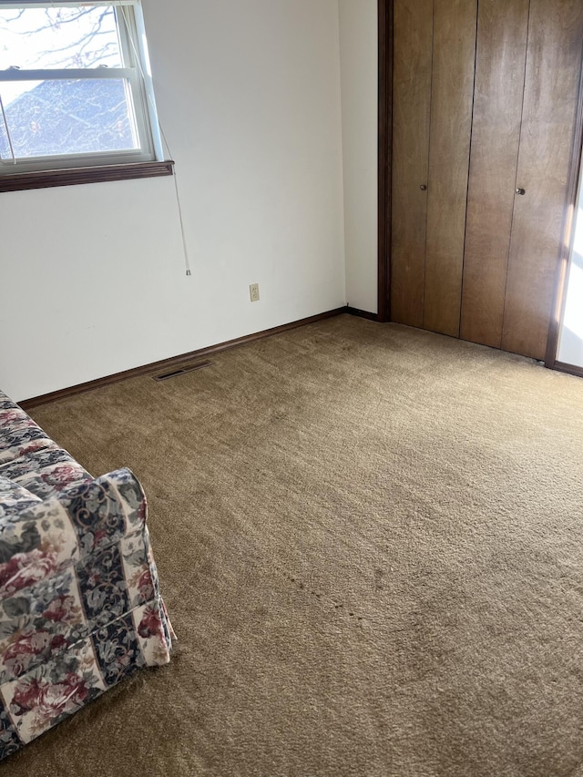 unfurnished bedroom with a closet and carpet