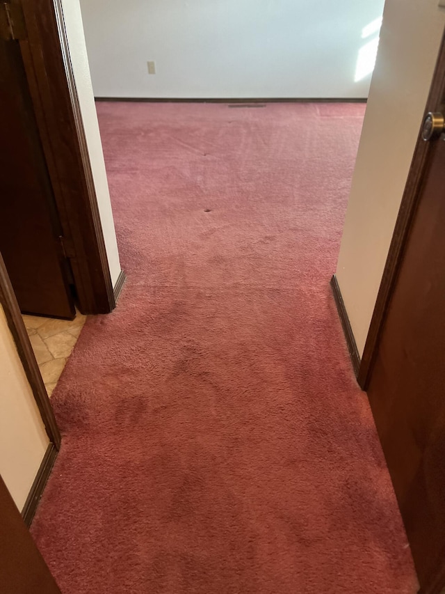 hallway with light colored carpet