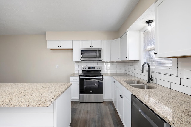 kitchen with sink, stainless steel appliances, white cabinets, and dark wood-type flooring