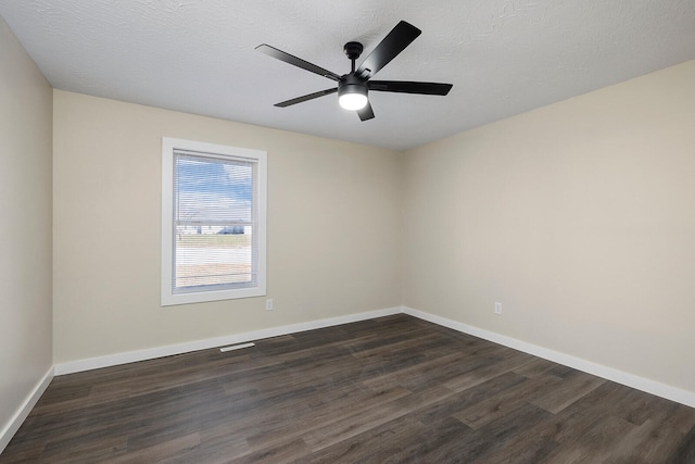 spare room with ceiling fan, dark wood-type flooring, and a textured ceiling