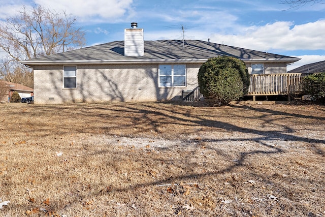 back of house with a deck and a lawn