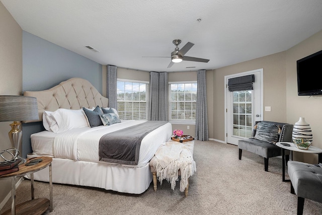 carpeted bedroom featuring a textured ceiling, ceiling fan, and access to outside