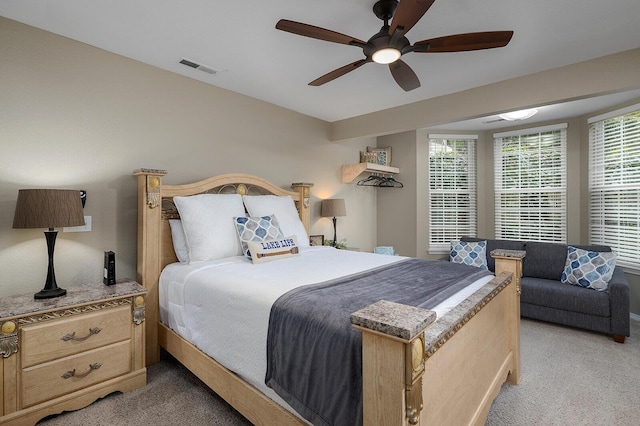 bedroom featuring light carpet and ceiling fan