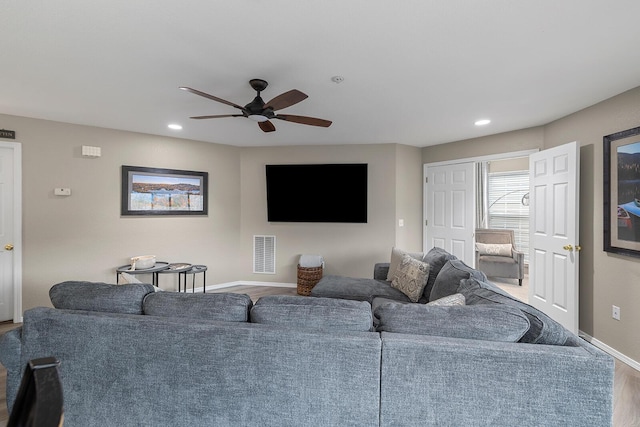 living room with hardwood / wood-style flooring and ceiling fan