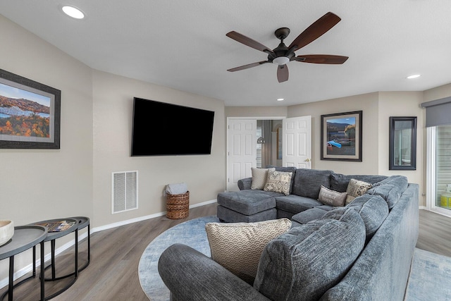 living room with hardwood / wood-style flooring and ceiling fan