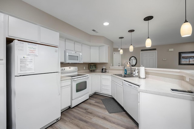 kitchen with white cabinetry, sink, white appliances, and hanging light fixtures