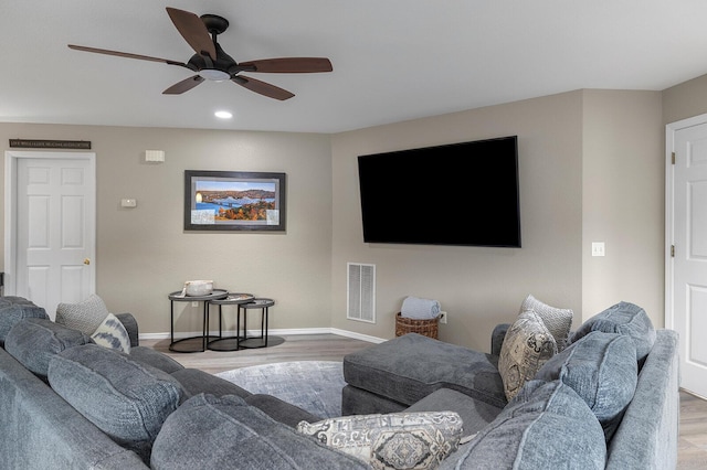 living room with hardwood / wood-style floors and ceiling fan