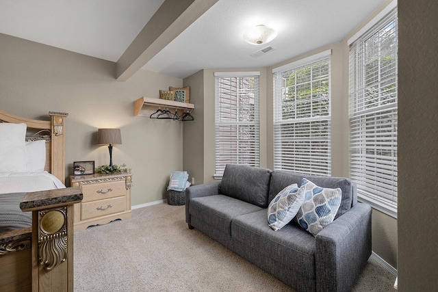 living room with beamed ceiling and carpet