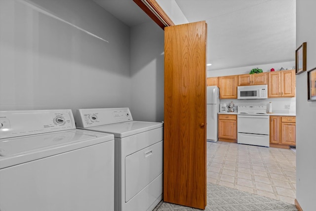 clothes washing area featuring separate washer and dryer