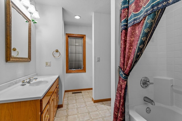 bathroom featuring vanity and shower / bath combo