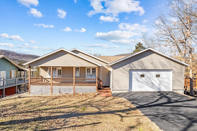 ranch-style home with covered porch and a garage