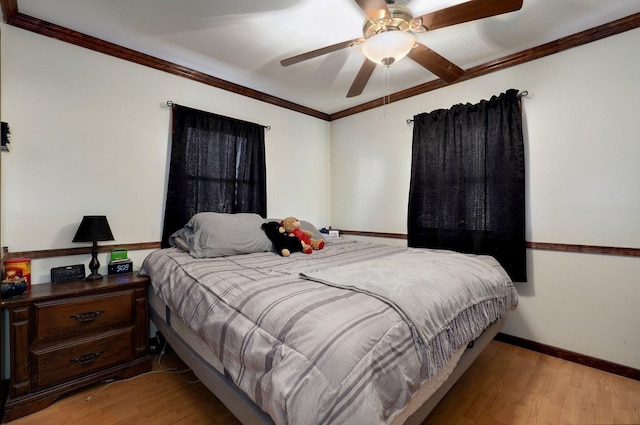 bedroom featuring ceiling fan, light hardwood / wood-style flooring, and crown molding