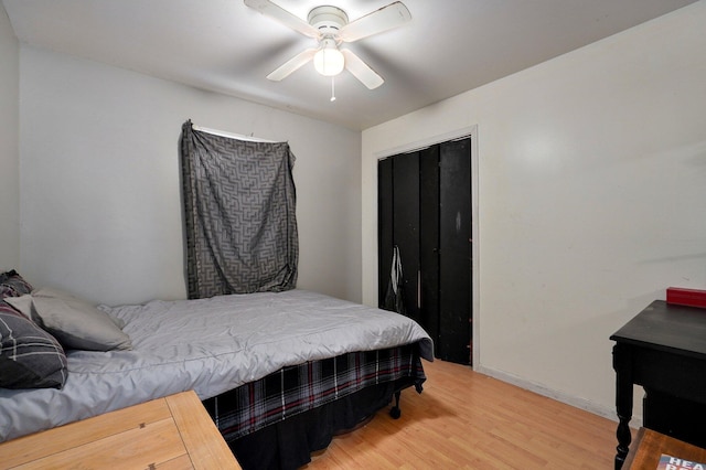 bedroom with wood-type flooring, a closet, and ceiling fan